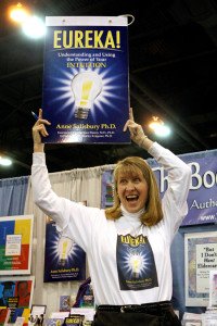 A woman holding up an advertisement for the book.