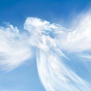 A white angel in the sky with clouds