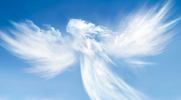 A white angel in the sky with clouds